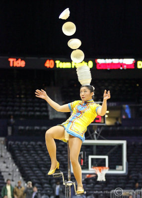 …Unicyclist lands the bowls during halftime…