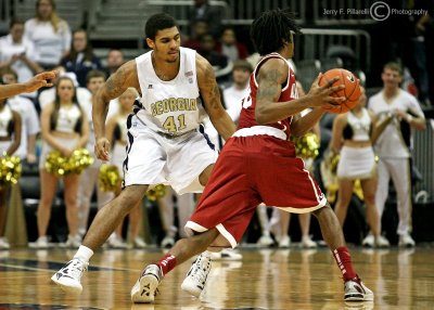 Jackets G Rice defends Tide ball handler G Levi Randolph