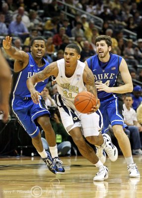 Yellow Jackets G Glen Rice Jr. drives around Blue Devils defenders