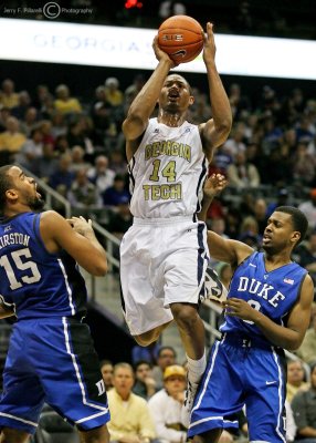 Jackets G Jason Morris pulls up to shoot over Blue Devils F Josh Hairston and G Tyler Thornton