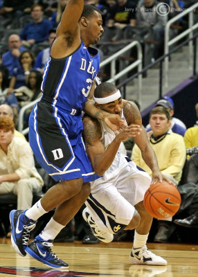 …Georgia Tech G Jordan works hard to get around Duke G Thornton