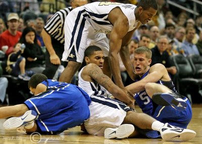 Georgia Tech G Rice goes to the floor to wrestle the ball from Duke F Mason Plumlee