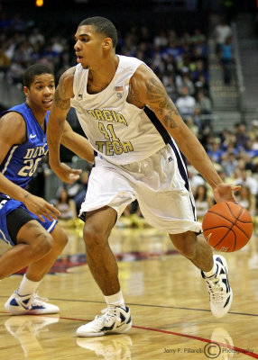 Yellow Jackets G Rice is chased by Blue Devils G Dawkins as he drives to the basket