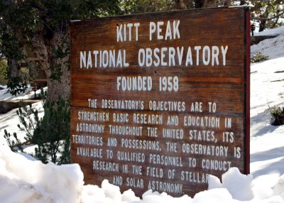Kitt Peak National Observatory sign surrounded by a snow drift