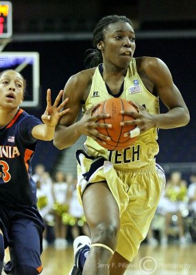Jackets G Marshall gets past Cavaliers G Franklin on her way to the hoop
