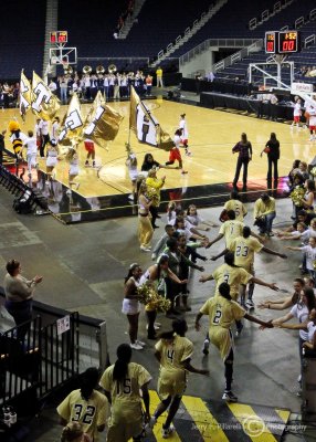 Yellow Jackets are led onto the court by the school colors prior to the game
