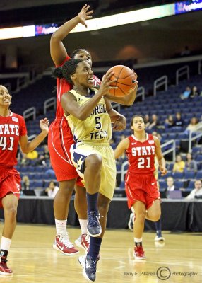 Georgia Tech PG Metra Walthour drives to the basket with NC State G Myisha Goodwin-Coleman in pursuit…