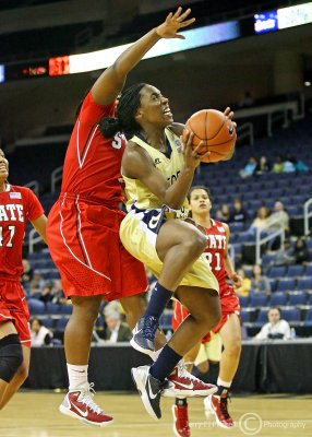 …Jackets PG Walthour elevates toward the basket after passing Wolfpack G Goodwin-Coleman