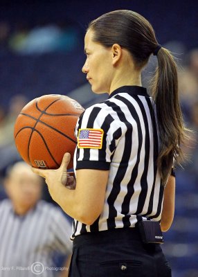 Referee stands her ground in the paint during a timeout