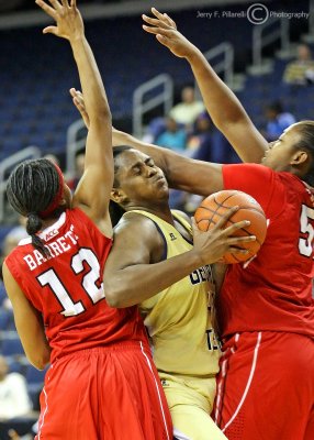 Georgia Tech C Goodlett fights for position under the basket with NC State G Barrett and F Kiana Evans