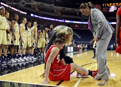 …Wolfpack G Tasler is attended to by Head Coach Harper and the trainer