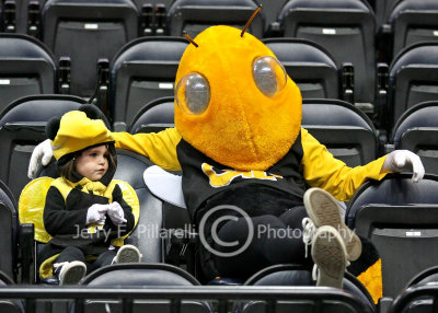Yellow Jackets Mascot Buzz sits with a baby Buzz before the game