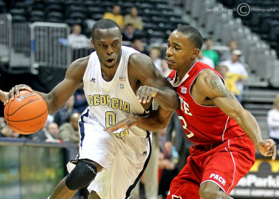 Georgia Tech G Mufon Udofia dribbles past North Carolina State G Alex Johnson