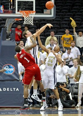 Jackets C Daniel Miller blocks the shot of Wolfpack F Richard Howell