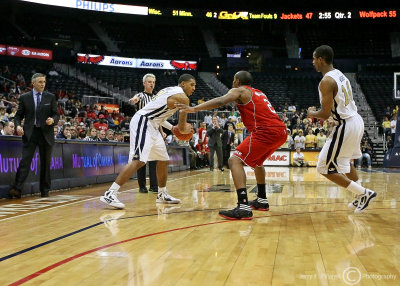 Jackets F Rice looks to drive around Wolfpack G Lorenzo Brown as G Morris moves to set a pick