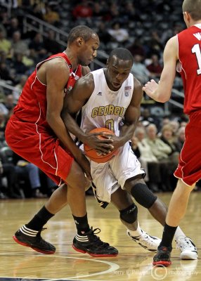 Jackets G Udofia struggles to get around a Wolfpack defender