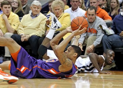 Clemson F KJ McDaniels passes to a teammate after beating Tech G Udofia to a loose ball