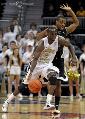 Georgia Tech G Udofia stays in front of a Wake Forest defender as he heads up court