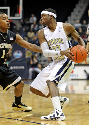 Yellow Jackets G Reed is guarded at the three point line by Demon Deacons G Tony Chennault