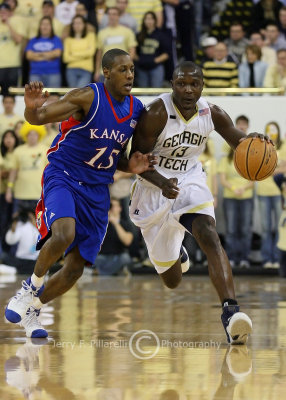 Georgia Tech F DAndre Bell charges up court with Kansas G Mario Chalmers in pursuit