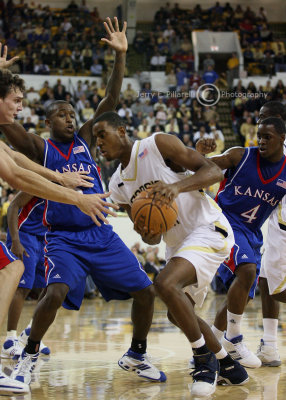 Tech F Alade Aminu is surrounded by Kansas defenders