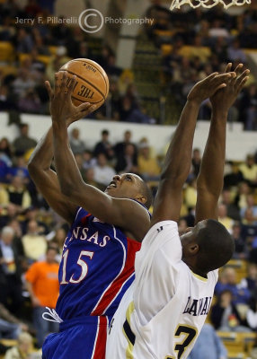 Jayhawks G Chalmers shoots from under the basket with Tech F Lawal defending