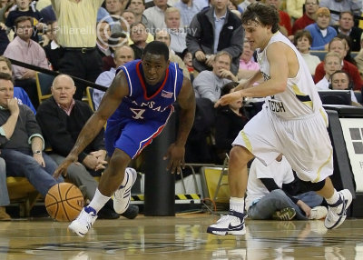 Yellow Jackets G Causey runs down Jayhawks G Collins