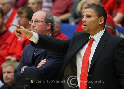 Arizona Head Coach Kevin ONeill watches as Assistant Coach Miles Simon gives direction to the players