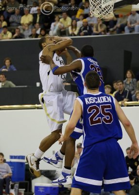 Yellow Jackets G Miller drives on Blue Hose G Brian Bostic
