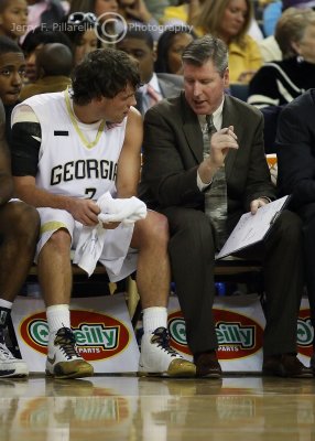 GT Assistant Coach John OConner works with G Causey on the bench