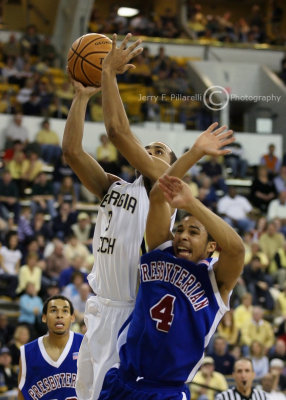 Yellow Jackets G Miller drives over Blue Hose G Miller for a late basket