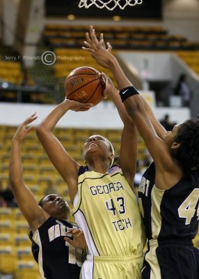 GT G Nnamaka powers through resistance to take a shot under the basket