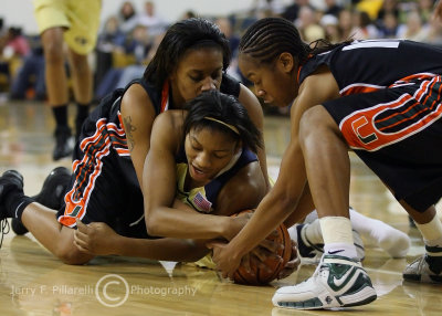 Tech G Williams fights for a loose ball with two Miami players