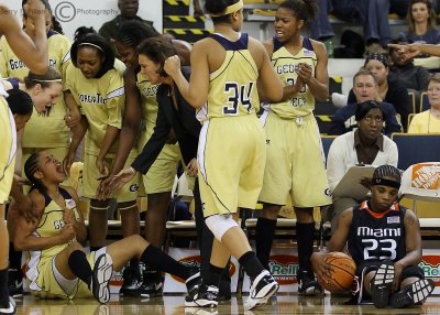 Jackets G Ingram celebrates with teammates after forcing a turnover from Canes G Latoya Cunningham