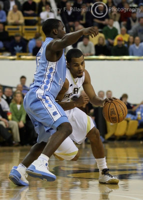 Jackets G Maurice Miller lowers his shoulder to drive around Heels G Ty Lawson