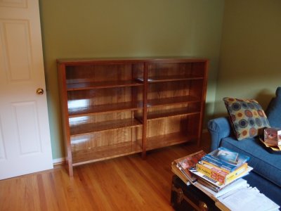 Bob finally moved his cherry bookcase into his office.
