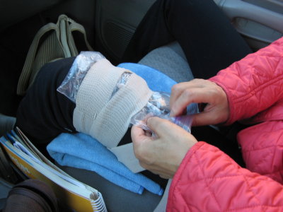 she injured her knee. She put ice on it on the drive home