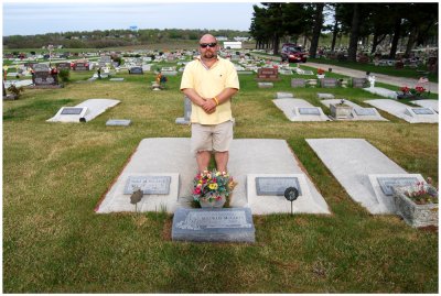 Richard Mann, standing at the graves of his cousins, Hilda & Mildred McCarty. Note the landmark watertower in the far background.