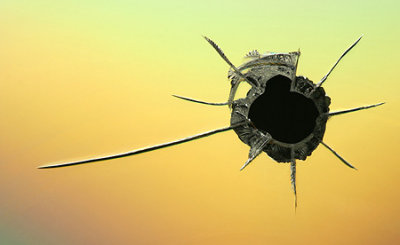 Fun with a Red Ryder. This is 'Potshot'. It's a macro of a BB hole that I shot through a CD...and no, I did not shoot my eye out. :-) Taken with a Canon 350D and 70-200 f/4 with 500D close up diopter.