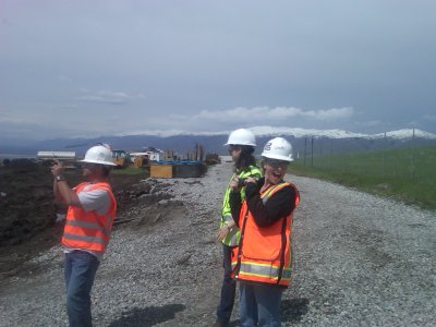 Adam in his PPE in the pipeyard with Halli and Lindsey