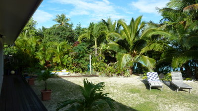 The backyard, looking left from the veranda.  Access to the beach is right behind the lounges.