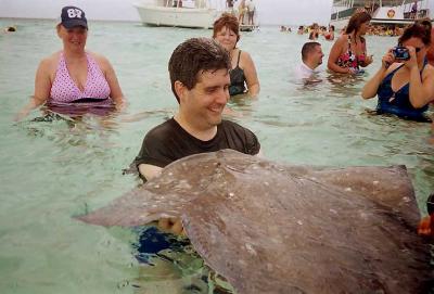 Jim feels the wet velvet skin of the stingray.