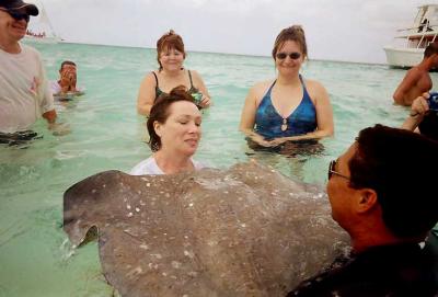 Shelley takes her turn cradling the stingray with the help of Soto's guide.