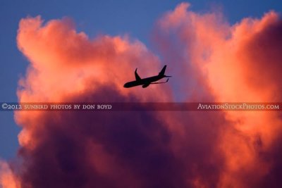 2012 - American Airlines B757-223 N183AN flying past colorful clouds over Miami lakes after sunset aviation stock photo