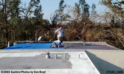 Manny and Eddie installing tarps on roof after Hurricane Wilma photo #7133