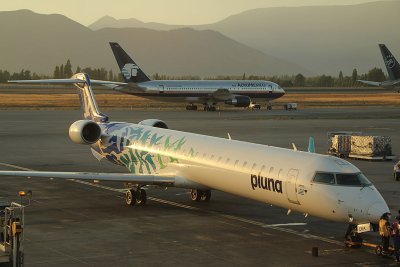 Pluna CRJ-900 being lit by the setting sun in SCL