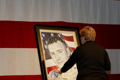 Mother Michelle Bryant touches the portrait