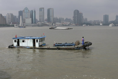 The muddy Huangpu River runs through Shanghai, & the river traffic never ends.