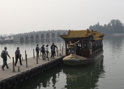 A dragon boat with the Marble Bridge in the background.