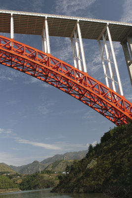 We went under a bright red and white new bridge in Wushan.